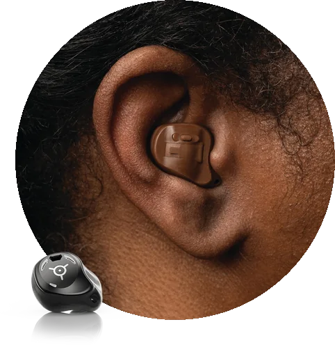 An ear with a Phonak custom shell filling the bowl of the ear, and a Phonak in the ear hearing aid shown alongside