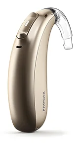 A Phonak Naïda behind the ear hearing aid in champagne: the unit sits behind the ear with a clear tube that runs to an earmould