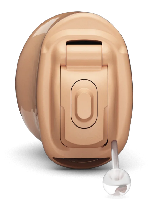 A Phonak Virto completely in canal hearing aid in beige: a small custom device that sits deep in the ear canal, with a clear removal cord